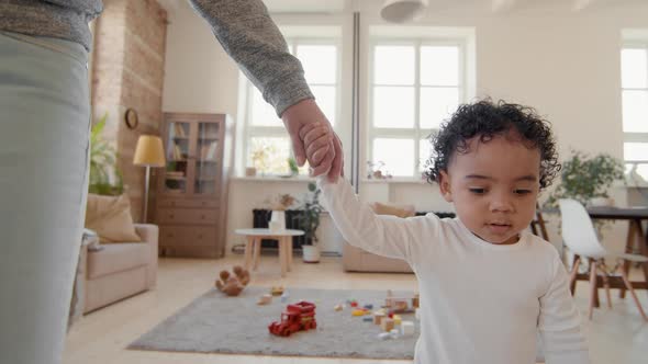 Cute Toddler Walking with Mother in Living Room alt