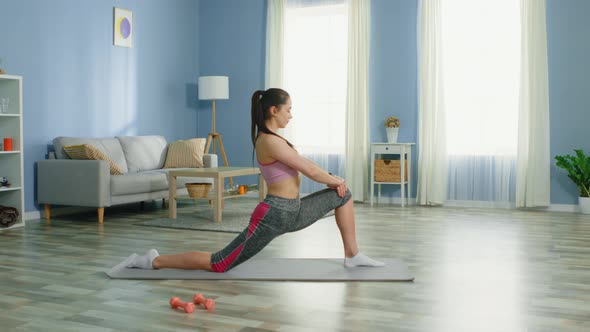 Young Woman Is Doing Hip and Leg Stretching