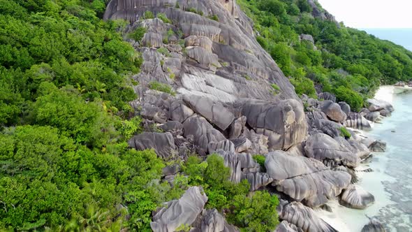 a beach with big rocks and a huge rock