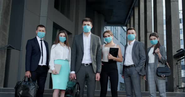 Professional Business People in Protective Mask Look at Camera