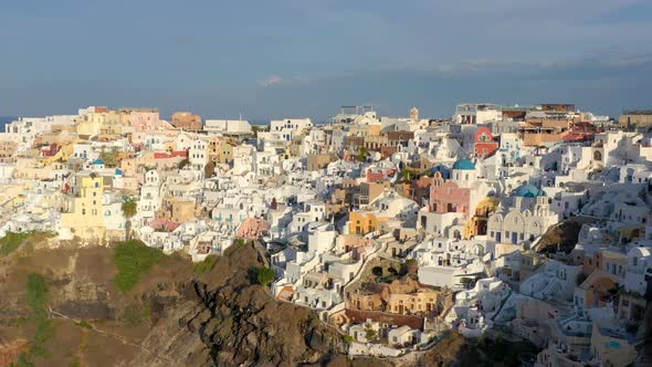 Aerial shot of famous Oia village in Santorini at sunrise in Greece