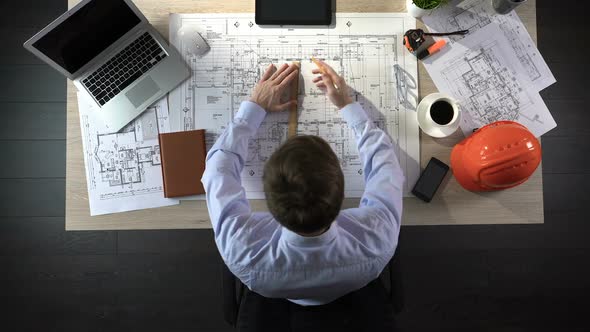 Representative of Construction Company Preparing Drawing of Office Building