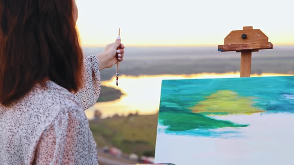 Painting Outside Young Woman Drawing a Painting Inspired By the Sunset and Fields Measuring the