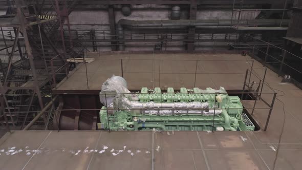 Green Engine in Hold of Old Repairing Crab Ship in Dry Dock