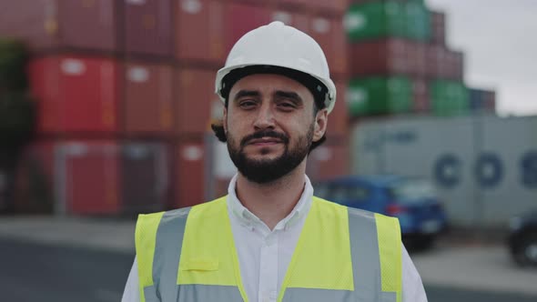 Man in Safety Helmet and Vest Posing at Cargo Harbor