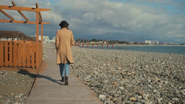 Girl Taking a Lonely Stroll on a Beach.