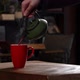 Cinematic Slow Motion Pouring Herbal Tea in Red Mug from Green Tea Pot - VideoHive Item for Sale