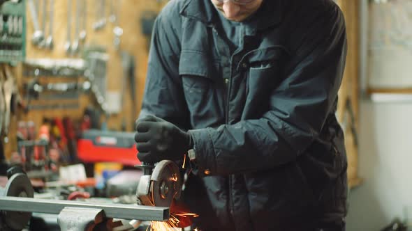 Angle Grinder Cutting Metal at Workshop