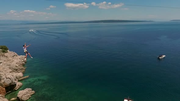 Aerial view of a person going on zipline at Losinj coastline, Croatia.