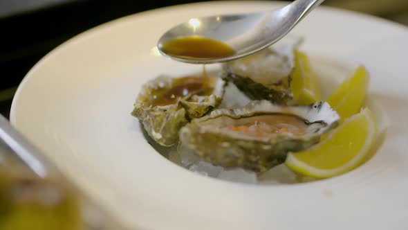 Chef Preparing Oysters Dish in Elegant Restaurant.