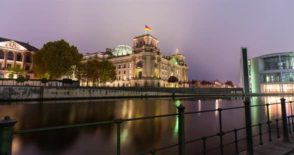 Sunrise hyper lapse of the Reichstag government building in central Berlin, spree river water front