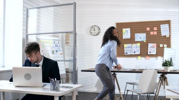 Young Woman Learning Good News and Dancing in Office