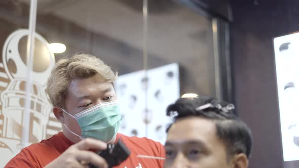 A Video of a Barber Making Haircut to Attractive Man in Barbershop