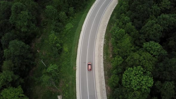 Drone Point of View Tracking Mode Aerial View Flying Over Two Lane Countryside Forest Road with