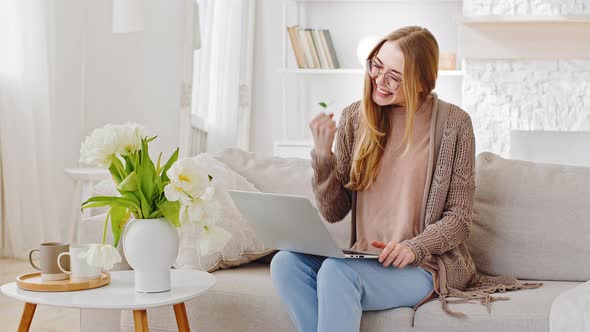 Caucasian Millennial Young Girl Brunette Woman with Laptop Sitting at Home on Sofa Playing Online