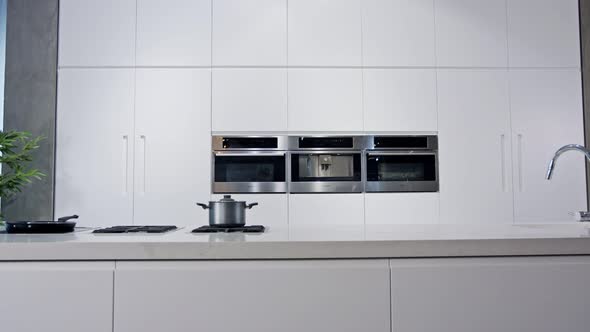 Tracking shot of a luxury kitchen with white modern design