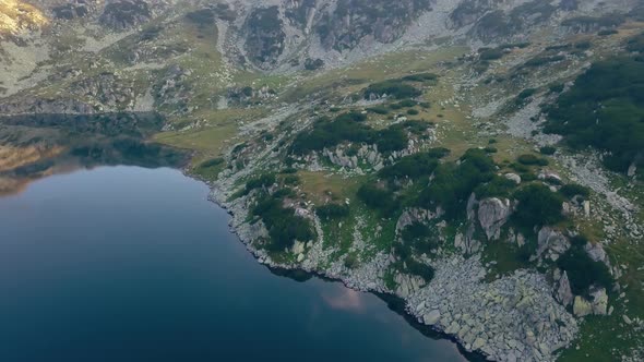 Wide aerial drone slowly rotating right framing onto a mountain range.