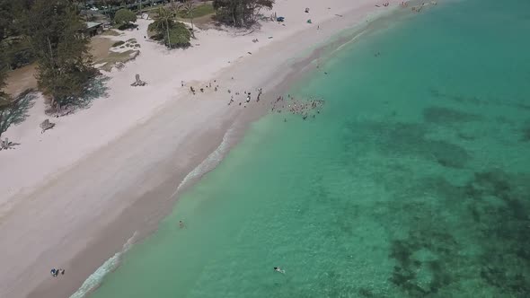 Aerial view of kids playing in the ocean at Kailua Oahu on a sunny day