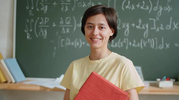 Portrait of Cheerful Female Student in Classroom