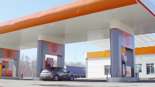 Car Filling Up at Gas Station