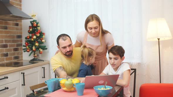 Caucasian Family Sit in Kitchen Together