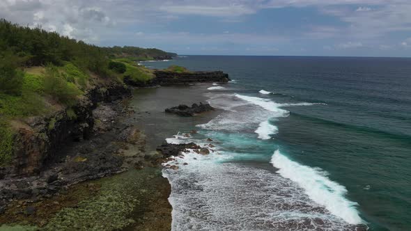 Bird's-eye view of Cape Gris Gris, waves rolling over natural rock formations, Mauritius.