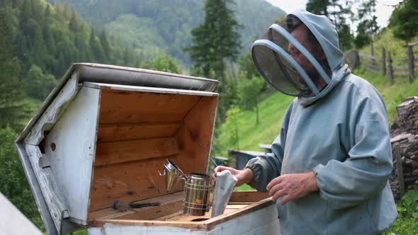 Beekeeper Is Working at Apiary