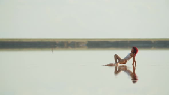 Flexible Young Woman in Bathing Suit Is Dancing in the Water, Seaside, 