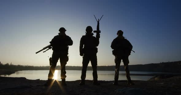 Three Soldiers Posing with Guns alt