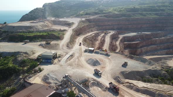 Aerial View of Industrial Opencast Mining Quarry with Lots of Machinery at Work Extracting Fluxes