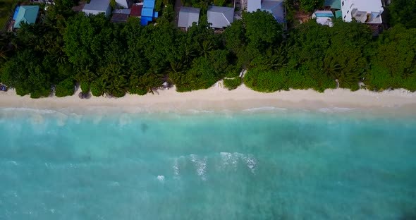 Luxury fly over island view of a sandy white paradise beach and aqua blue ocean background 