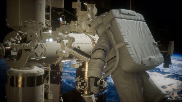 International Space Station and Astronaut in Outer Space Over the Planet Earth alt