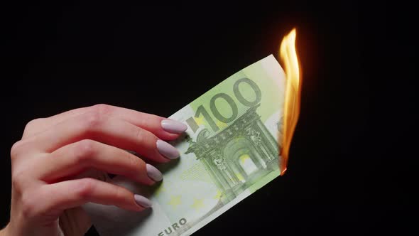 Burning of One Hundred Euro Banknote on Black Background