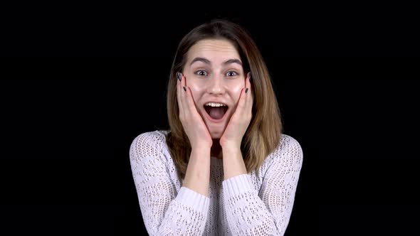 The Young Woman Shows Emotions of Surprise on Her Face. Woman Is Surprised Opening Her Mouth on a