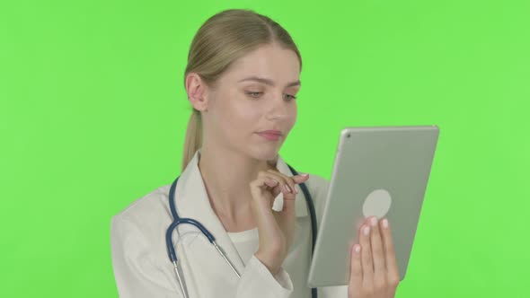 Female Doctor using Digital Tablet on Green Background