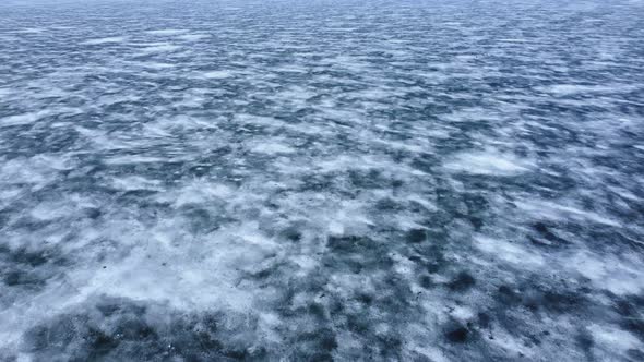 Beautiful top view of the northern arctic nature. Endless water surface, covered with ice and snow.