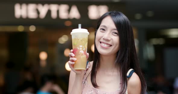 Woman drinking of fruit tea