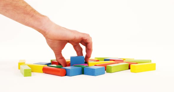 Man hand playing building blocks