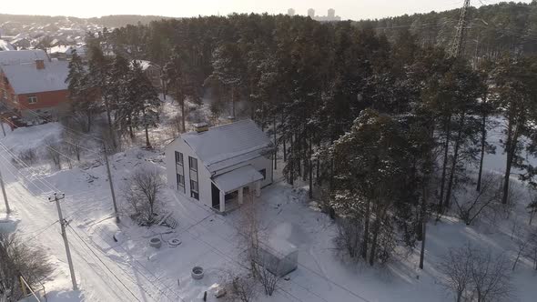 Aerial view of new white modern residential house at winter near the forest 11