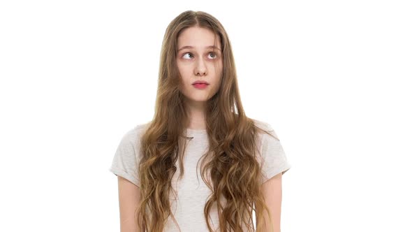 Portrait of Young Cute Teenage Woman 17 Years Old Blowing Lock of Her Brown Long Hair in Slow Motion
