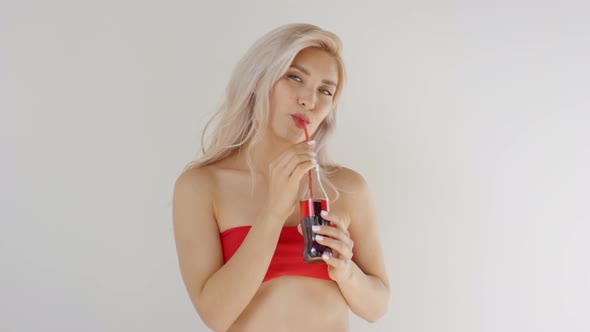 Young Caucasian Blonde Posing with Soda Drink in Glass Bottle