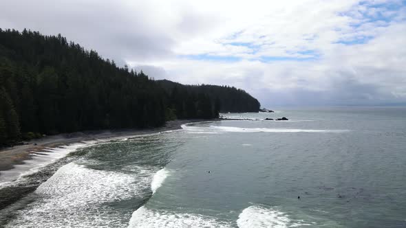 Drone slowly flying along Sombrio beach on Vancouver Island during a cloudy spring morning. Multiple