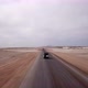 Car Driving on Gravel Road in Aerial Desert - VideoHive Item for Sale