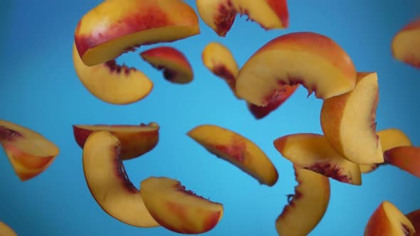 Peach Slices Bounce on a Blue Background