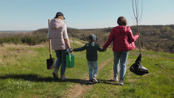 Family Going to Plant a Tree on Nature