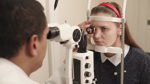 Oculist Works in Policlinic the Man Uses the Device for Biomicroscopy of an Eye