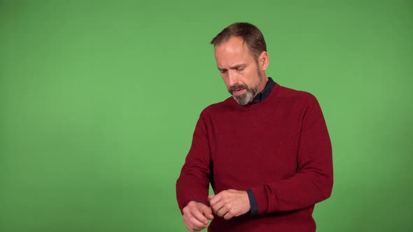 A Middleaged Handsome Caucasian Man Adjusts His Clothes and Smiles at the Camera  Green Screen