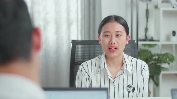 Asian Woman Interviewee Answering The Questions Be Asked By A Businessman