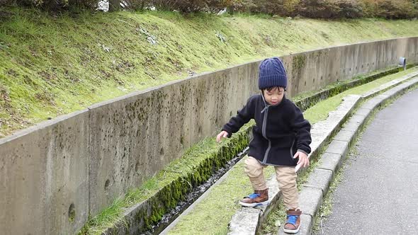 Cute Asian Child Playing In The Park 