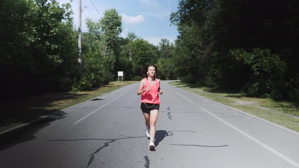 Young Skinny Fit Girl Starts Her Running Workout in City Park